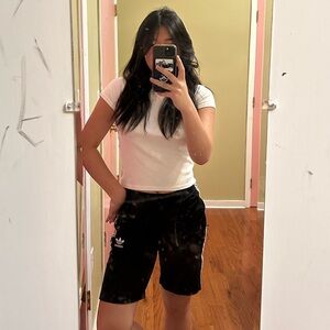 Long Adidas classic black and white-striped shorts.